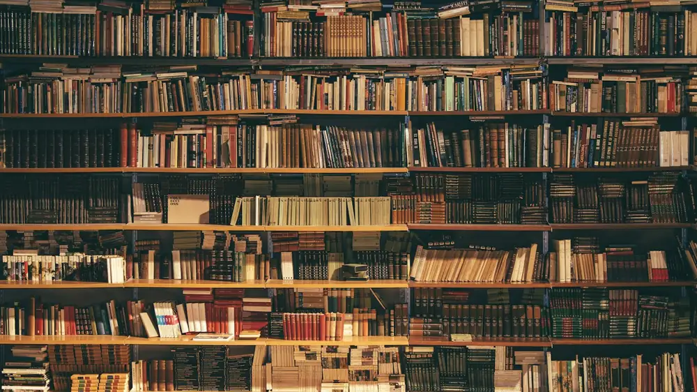A shelf where books and paperwork have defined, limited space